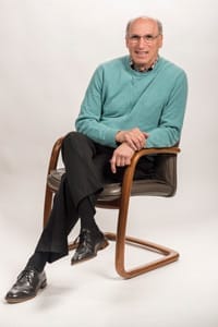 Dr. Calcagno smiling and sitting in a chair