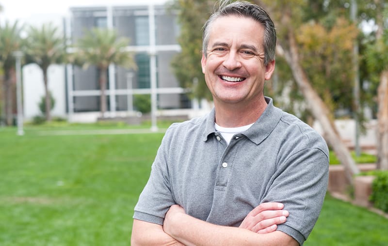 Mature, happy dental implant Rochester, NY patient